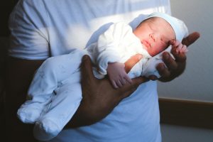 Parents holding their newborn baby with love and affection