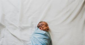 Newborn baby sleeping peacefully during a photo shoot